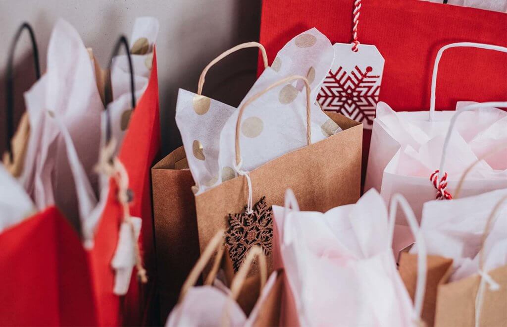 red and white christmas gift bags with tissue paper