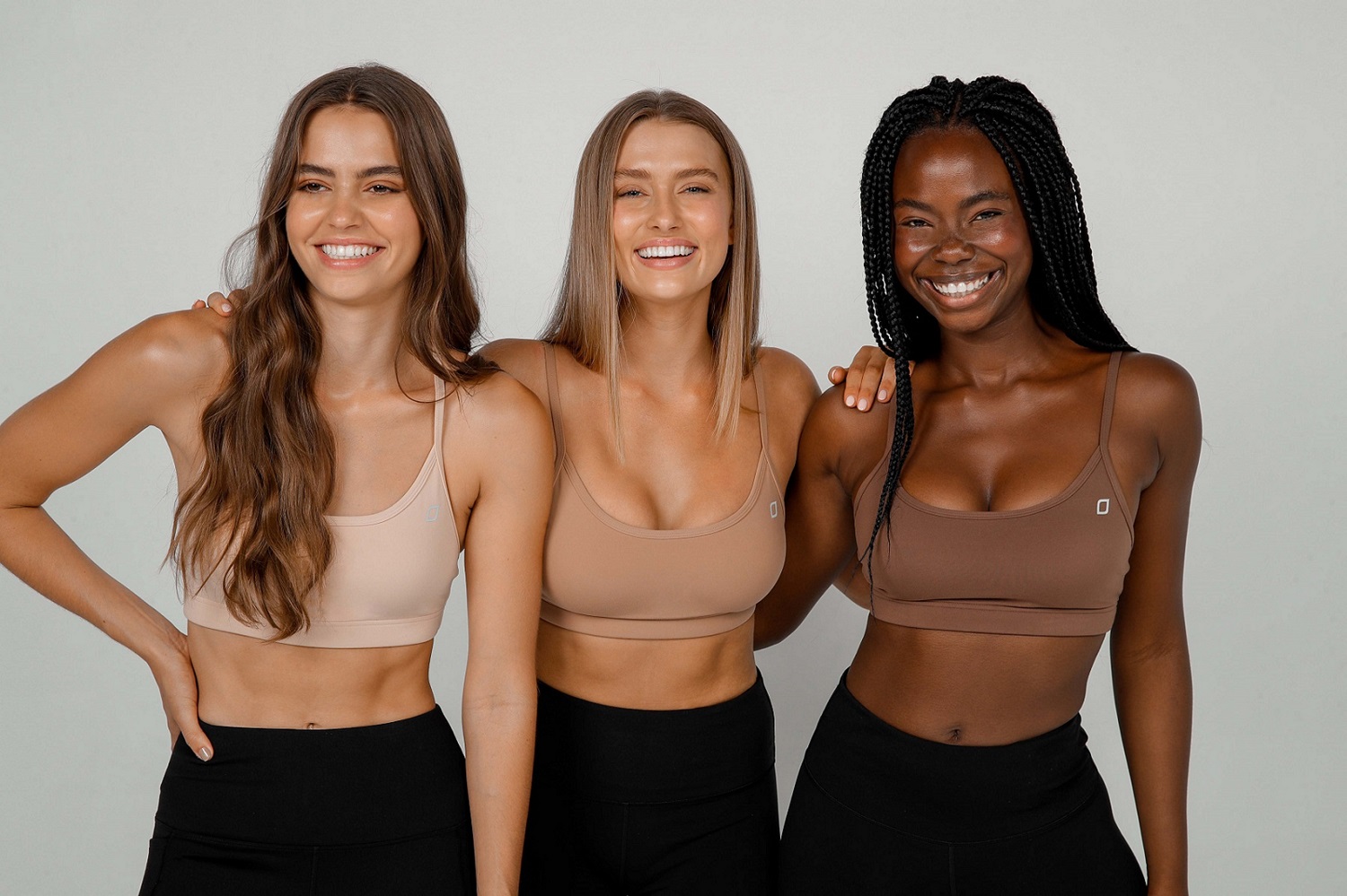 three women wearing nude sports bras with high support