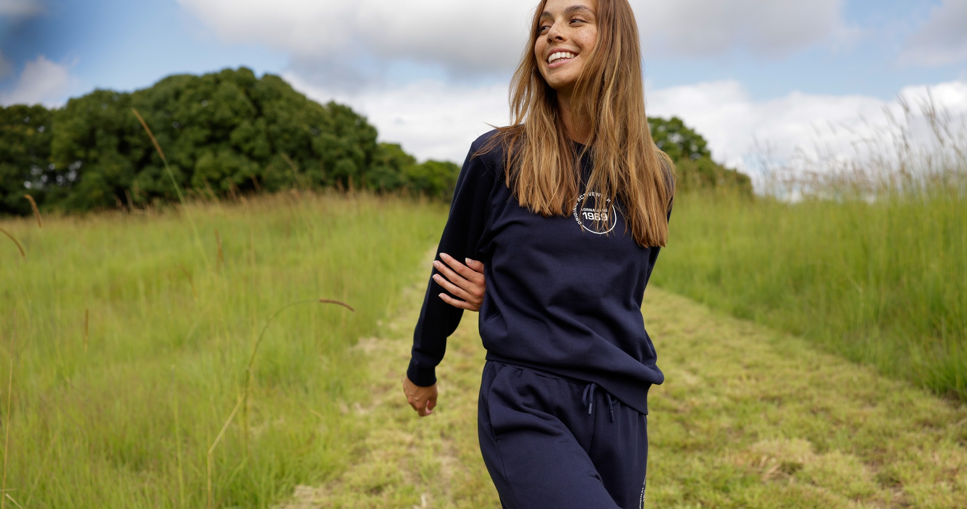 woman wearing matching navy trackpants and sweater